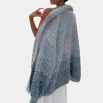 Silver sequin bridal shawl for women, elegantly draped as an evening wrap with shimmering sequins, showcasing a fashionable design over the shoulders.