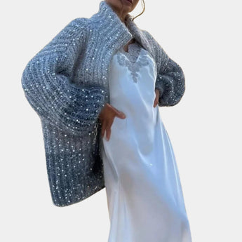 Elegant silver sequin bridal shawl with a shimmering finish, designed as a women's evening wrap, displayed in a blue color variant, size XL, draped over a one-piece dress with visible neckline and sleeves.