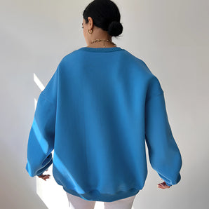 Sky blue oversized women's sweater with long sleeves and a round neck, featuring a comfortable and cozy design ideal for fall fashion.