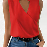 Sleeveless white wrap blouse with an elegant V-neck design, suitable for business attire.