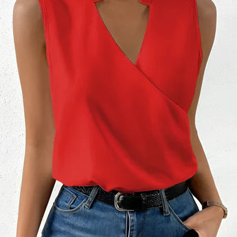 Sleeveless white wrap blouse with an elegant V-neck design, suitable for business attire.