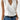 Sleeveless white wrap blouse featuring an elegant V-neck design, suitable for business attire.