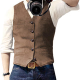 Slim-fit blue denim vest for men with button-up front and collar, worn over a white dress shirt.
