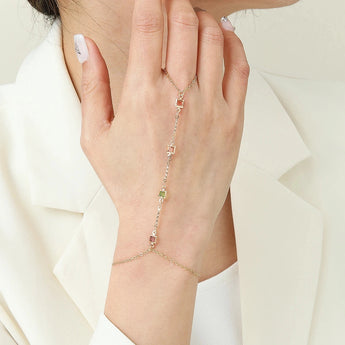 A woman's hand wearing a dainty, adjustable bracelet with a star charm, elegantly displayed on the wrist.