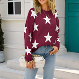 Blue and white crewneck sweater with a star pattern, featuring long sleeves and a casual knit design, styled with jeans for a fashionable look.