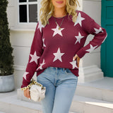 Blue and white star pattern crewneck sweater worn by a person standing, paired with jeans, showcasing the sweater's casual knitwear design with long sleeves.