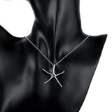 Sterling silver starfish jewelry set including necklace, bracelet, and earrings displayed against a dark background.