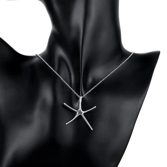 Sterling silver starfish jewelry set including necklace, bracelet, and earrings displayed against a dark background.
