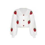 Women's trendy V-neck strawberry knit cardigan sweater with long sleeves, featuring a carmine color and pattern, showcased on a model.