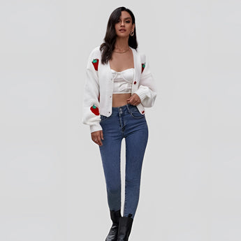 Women's trendy V-neck cardigan in strawberry knit design, showcased with jeans, highlighting the sleeve, shoulder, and waist details.