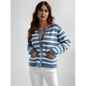 Striped blue and white knit cardigan with a button-up front, featuring a casual chic design. The sweater has a collar, long sleeves, and a comfortable fit around the waist, showcasing a stylish blend of outerwear and sportswear aesthetics.