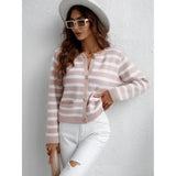 Striped blue and white knit cardigan, casual chic button-up sweater with long sleeves and a white collar, worn by a person.