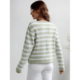 Striped blue and white knit cardigan featuring long sleeves, a button-up front, and a casual chic style, worn by a person smiling.