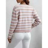 Striped blue and white knit cardigan with button-up front, showcasing casual chic style. The sweater features long sleeves, a round neckline, and a fitted waist, perfect for layering as outerwear.