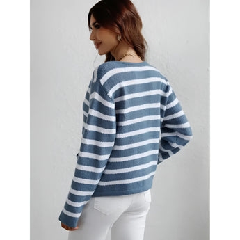 Striped blue and white knit cardigan with buttons, featuring a casual chic style, displayed on a person smiling and wearing the sweater with a T-shirt underneath, highlighting the collar, sleeves, and overall comfortable fit.