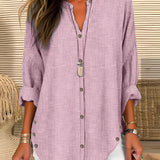 A striped blue and white women's V-neck blouse, featuring long sleeves, suitable for beachwear.