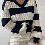 A marine blue XL striped cable knit women's sweater with puff sleeves and a crewneck design.