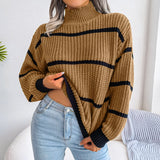 Tan and black striped chunky turtleneck sweater with long sleeves, designed for casual winter wear, styled on a mannequin showing shoulder and neck details.