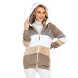 
A woman smiling and showcasing a khaki 3XL striped fleece hooded Sherpa jacket with warm colorblock plush. The jacket features long sleeves and a cozy hood, emphasizing comfort and style.