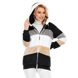 A woman wearing a black and white striped fleece hooded Sherpa jacket in size 3XL, featuring a warm colorblock design. The jacket has a plush texture and is styled with comfortable sleeves and a cozy hood. The woman is smiling with her hand raised near her face, showcasing the jacket's fit and style.