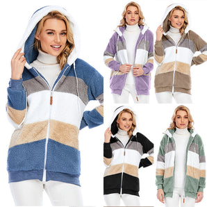 Striped fleece women's hooded sherpa jacket in warm colorblock design, showcasing a plush texture with a cozy hood, visible sleeves, and a comfortable fit around the neck and waist. The woman wearing the jacket is smiling, emphasizing the jacket's fashionable and cozy design.