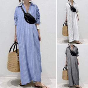 Striped maxi shirt dress with long sleeves in a lightweight fabric, featuring a combination of white and blue stripes. The dress is suitable for beachwear and has a relaxed fit, perfect for a casual and stylish look.