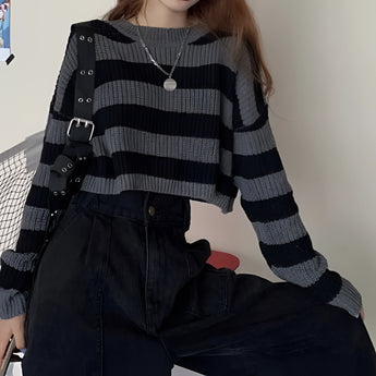 Striped oversized black and white knit sweater featuring long sleeves and a crew neck, perfect for trendy autumn fashion.