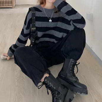 Striped oversized black and white knit sweater featuring long sleeves and a high collar, worn by a model showcasing the trendy autumn fashion style.