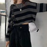 Striped oversized black and white knit sweater with long sleeves, featuring a trendy autumn fashion design. The sweater is shown in a black and white color scheme, emphasizing its distinctive striped pattern and cozy fit, suitable for an XL size.