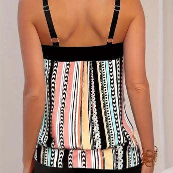 Women's striped tankini top with adjustable straps, featuring black and white stripes, modeled against a plain background. The beachwear showcases a sleeveless design, highlighting the shoulders and neck area.