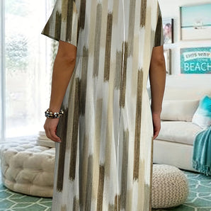 Striped tunic dress featuring a blue and neutral color scheme, with a knee-length design. The dress has a round neckline, short sleeves, and a relaxed fit around the waist, highlighting a casual summer fashion style.