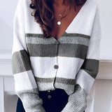 Striped V-neck button-front two-tone women's cardigan sweater in black and white, worn by a person, showcasing the sleeves and neckline.