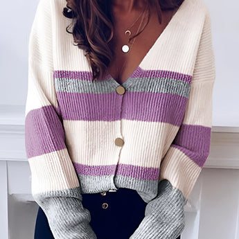 Striped V-neck button-front two-tone women's cardigan sweater in white and purple, displayed on a mannequin with emphasis on the shoulder and neckline details, suitable for casual fashion.