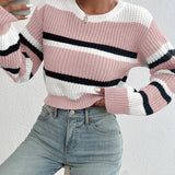 Striped women's black and white crew neck sweater featuring a chic winter knitwear design. The sweater is shown on a model showcasing the shoulder and sleeve details with a focus on the cozy textile and stylish neckline.