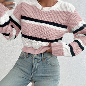 Striped women's black and white crew neck sweater featuring a chic winter knitwear design. The sweater is shown on a model showcasing the shoulder and sleeve details with a focus on the cozy textile and stylish neckline.