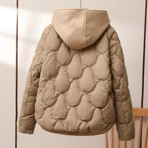 Stylish beige quilted insulated puffer jacket featuring a high collar, visible sleeves, and a fashionable pattern.