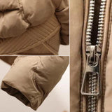 Stylish beige quilted insulated puffer jacket with a high collar, featuring long sleeves and a textured textile design.
