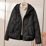 
A stylish black quilted insulated puffer jacket featuring a high collar and long sleeves, designed for fashion-forward individuals. The material appears natural, providing warmth and comfort, suitable for winter wear.