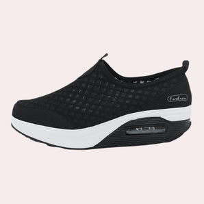 Stylish black slip-on mesh sneakers with air-cushion sole designed for comfort and performance, featuring a sleek and sporty design suitable for walking, running, and other athletic activities.