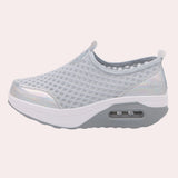 Sleek black slip-on mesh sneakers featuring an air-cushion sole, designed for comfort and style in outdoor and walking activities.