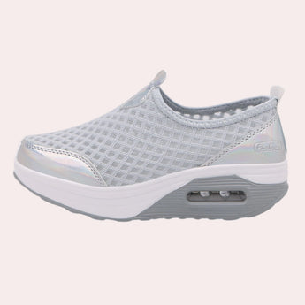 Sleek black slip-on mesh sneakers featuring an air-cushion sole, designed for comfort and style in outdoor and walking activities.