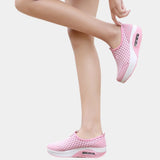 Comfortable and stylish pink slip-on mesh sneakers with an air-cushion sole, designed for optimal support and fashion appeal.