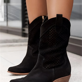 Stylish black women's perforated Western ankle cowboy boots with a pointed toe and low heel, showcasing a fashion-forward design.