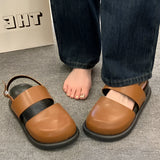 Stylish women's black platform orthopedic sandals featuring an ankle strap, shown on a person's foot with a focus on the fashion-forward design.