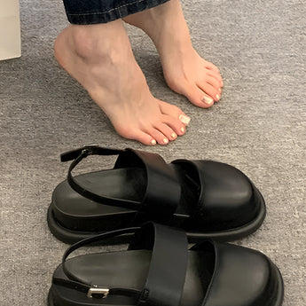 Stylish women's black platform orthopedic sandals with an ankle strap, featuring a sleek design and comfortable sole.