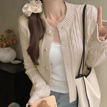 Stylish women's black quilted bomber jacket featuring gold button detail, worn by a model showcasing the shoulder and sleeve design.