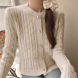 Stylish women's beige quilted bomber jacket featuring gold button detail with a collar and long sleeves.