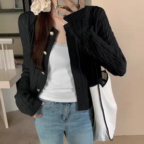 Stylish women's black quilted bomber jacket featuring gold button detail, highlighting the shoulder and waist areas with long sleeves and a comfortable fit.