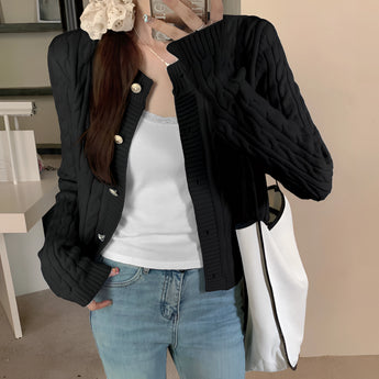 Stylish women's black quilted bomber jacket featuring gold button detail, highlighting the shoulder and waist areas with long sleeves and a comfortable fit.