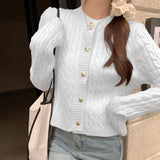 Stylish women's black quilted bomber jacket featuring gold button detail, with a structured collar and long sleeves.